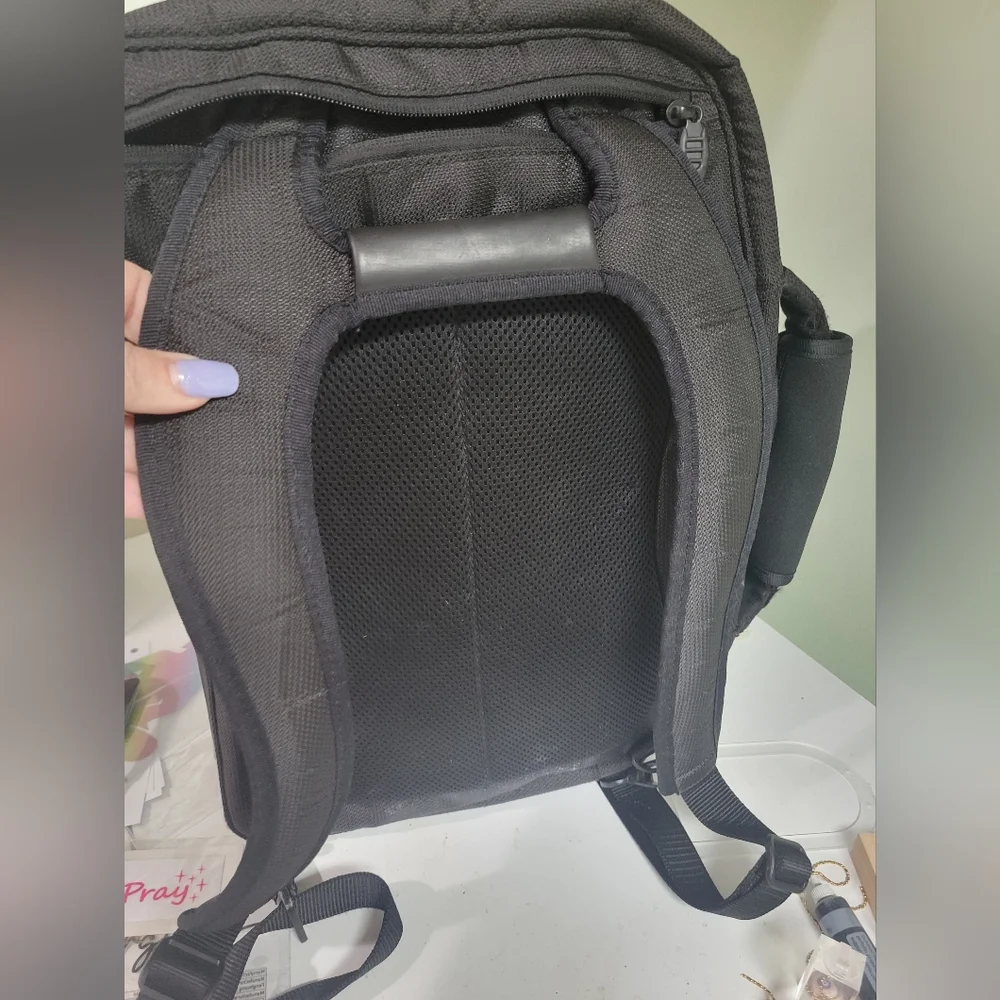 TUMI Black Backpack with Padded Straps and Multiple Compartments